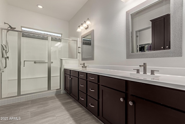 bathroom with vanity and a shower with door