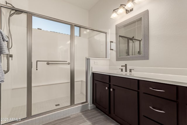 bathroom featuring vanity, an enclosed shower, and hardwood / wood-style flooring