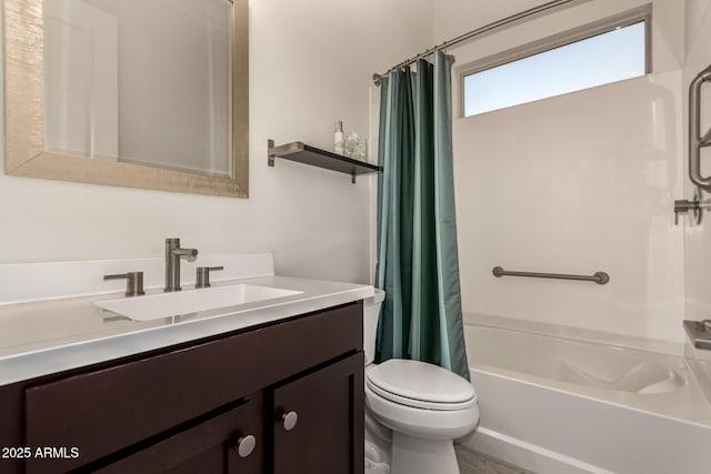 full bathroom with vanity, shower / tub combo, and toilet