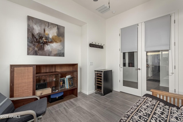 bedroom with beverage cooler and french doors