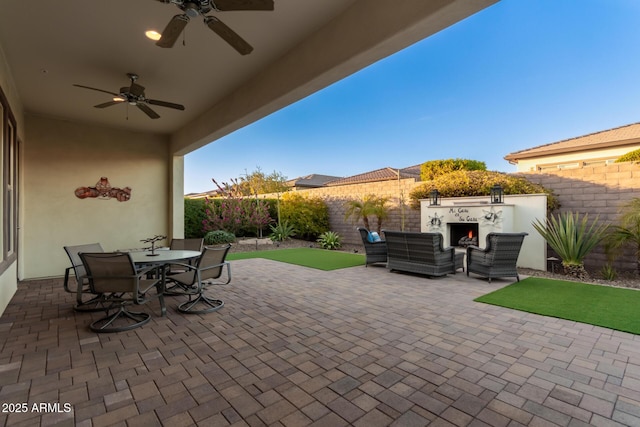 view of patio / terrace with an outdoor living space and ceiling fan