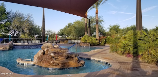 view of pool with a jacuzzi and a patio area