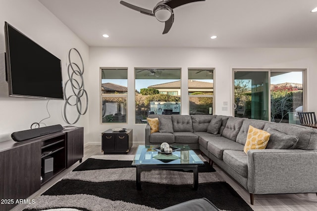 living room with hardwood / wood-style flooring, a healthy amount of sunlight, and ceiling fan