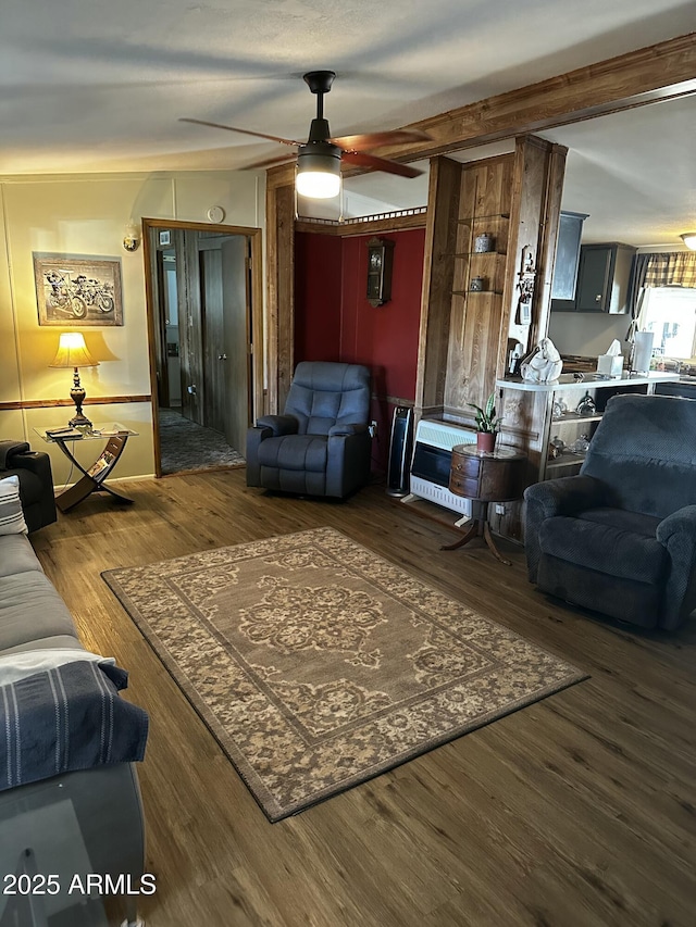 living room featuring dark wood-type flooring and ceiling fan