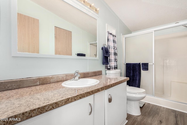 13638 S Sage Brush Dr, Mayer, AZ 86333 - full bath with toilet, vanity, a shower stall, wood finished floors, and a textured ceiling
