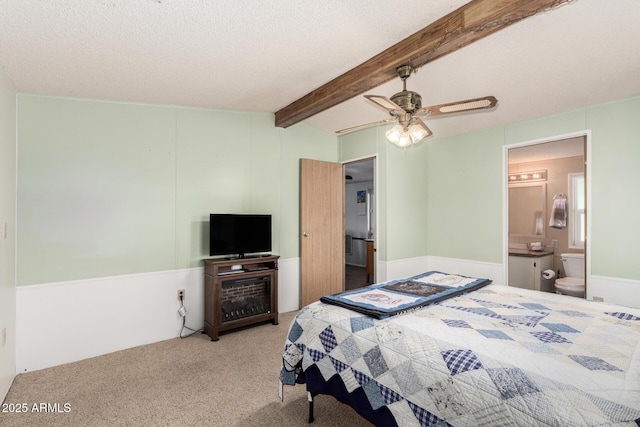 13638 S Sage Brush Dr, Mayer, AZ 86333 - bedroom with carpet flooring, beamed ceiling, ensuite bath, ceiling fan, and a textured ceiling