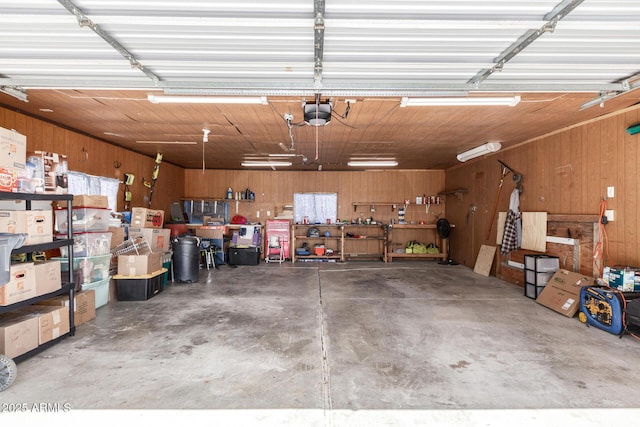 13638 S Sage Brush Dr, Mayer, AZ 86333 - garage featuring wooden walls, a workshop area, and a garage door opener