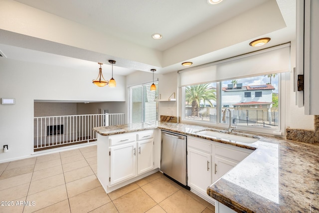 kitchen featuring a peninsula, a sink, white cabinets, dishwasher, and decorative light fixtures