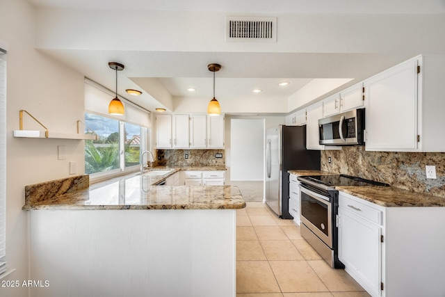 kitchen with visible vents, white cabinetry, appliances with stainless steel finishes, a peninsula, and light stone countertops