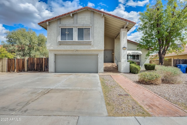 view of front of home featuring fence, stucco siding, concrete driveway, a garage, and a tile roof