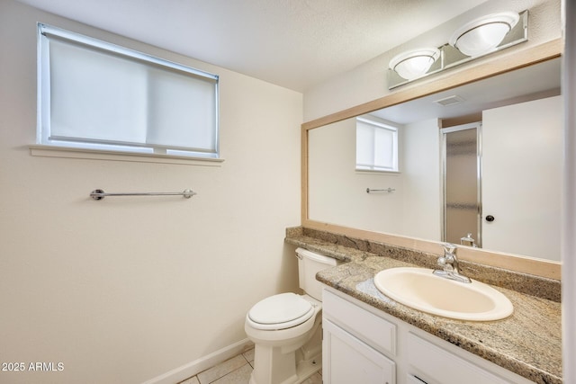 full bath featuring tile patterned floors, toilet, a shower stall, baseboards, and vanity