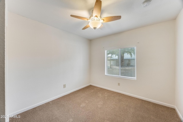 empty room with a ceiling fan, carpet, and baseboards