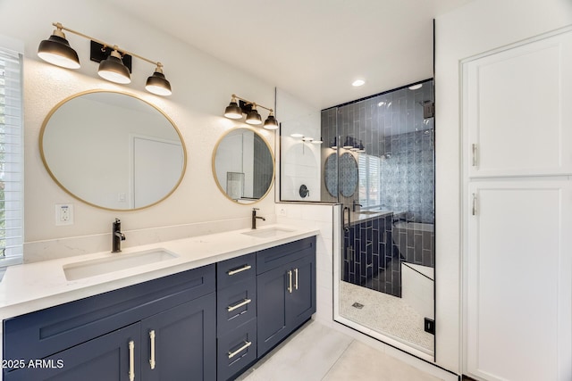 full bath featuring tile patterned flooring, double vanity, a stall shower, and a sink