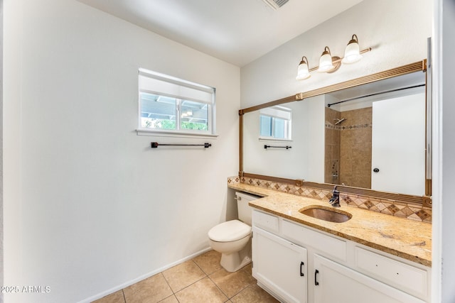 full bath featuring backsplash, toilet, tiled shower, tile patterned floors, and vanity