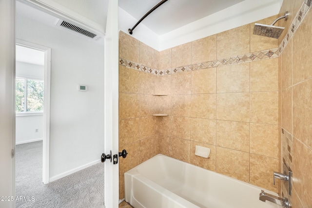 bathroom with visible vents, baseboards, and washtub / shower combination