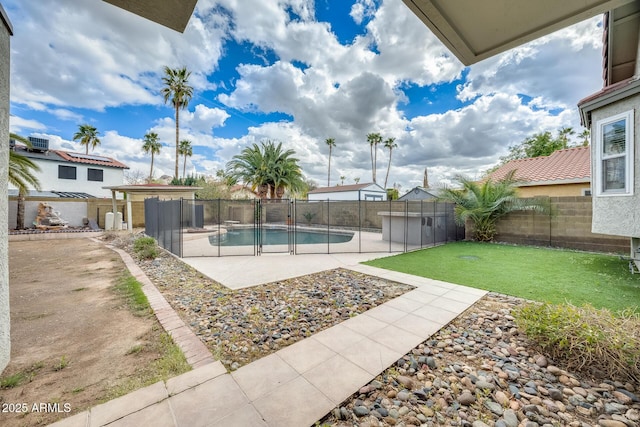 view of swimming pool featuring a fenced backyard, a lawn, a patio, and a fenced in pool