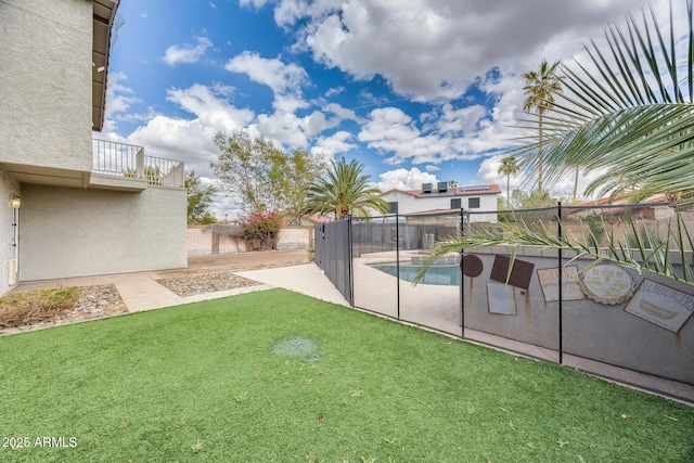 view of yard with a fenced backyard, a patio area, a fenced in pool, and a balcony