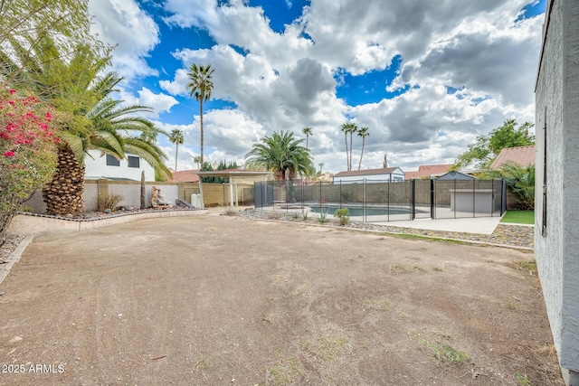 view of yard featuring a fenced in pool, a fenced backyard, and a patio area