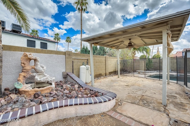 view of patio with central AC unit, a fenced backyard, and a ceiling fan