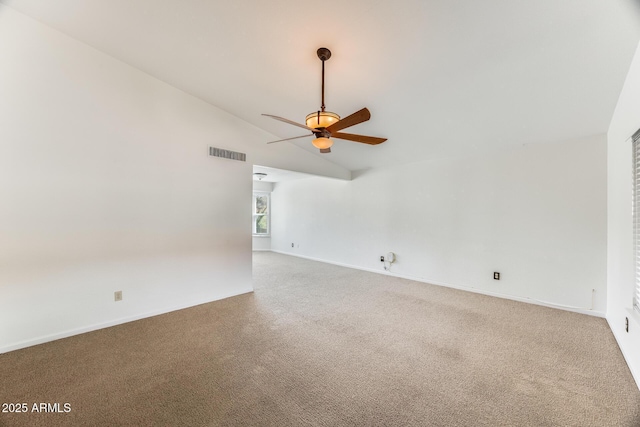 spare room featuring visible vents, baseboards, carpet flooring, lofted ceiling, and ceiling fan