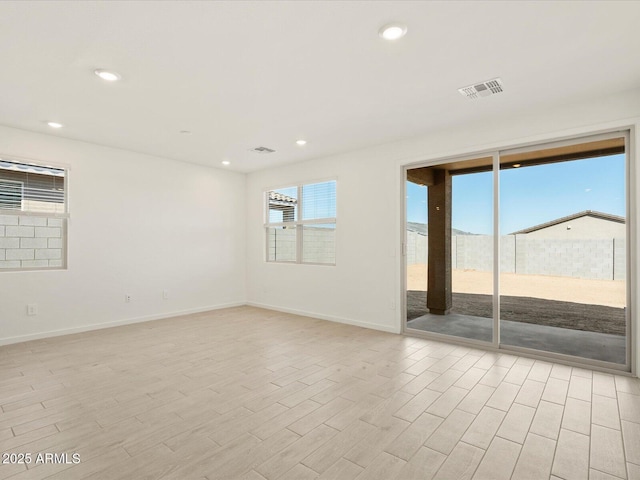 unfurnished room with visible vents, recessed lighting, baseboards, and light wood-style floors