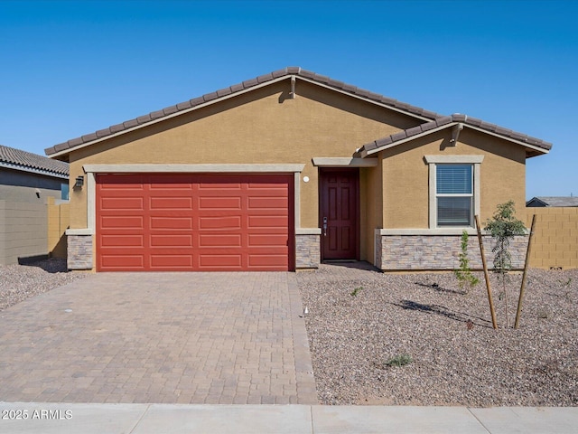 ranch-style house featuring stucco siding, decorative driveway, stone siding, a garage, and a tiled roof