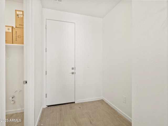 interior space featuring light wood-style floors and baseboards