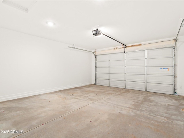 garage featuring a garage door opener and baseboards