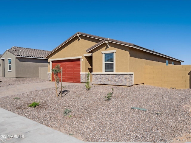 ranch-style home featuring stucco siding, stone siding, a garage, and fence