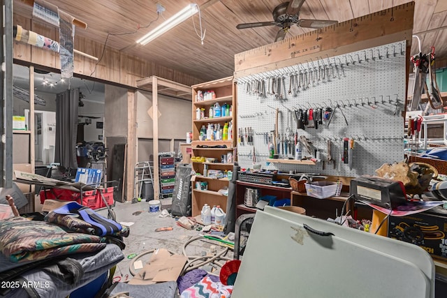 miscellaneous room with concrete floors, a workshop area, wood ceiling, and a ceiling fan