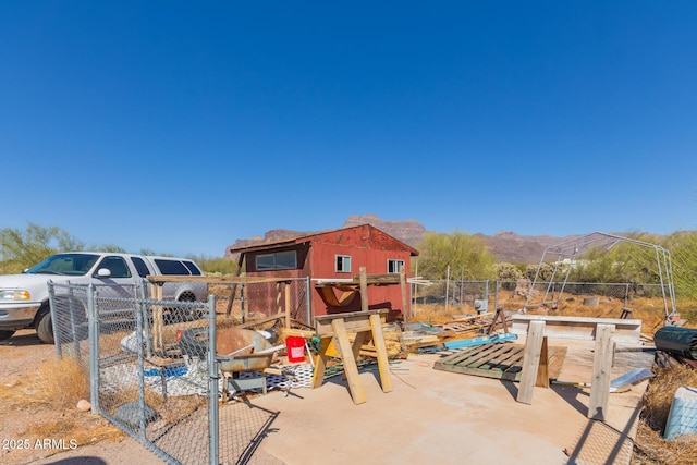 exterior space featuring a mountain view, a patio, and fence