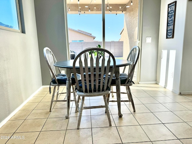 dining area with plenty of natural light and tile patterned floors