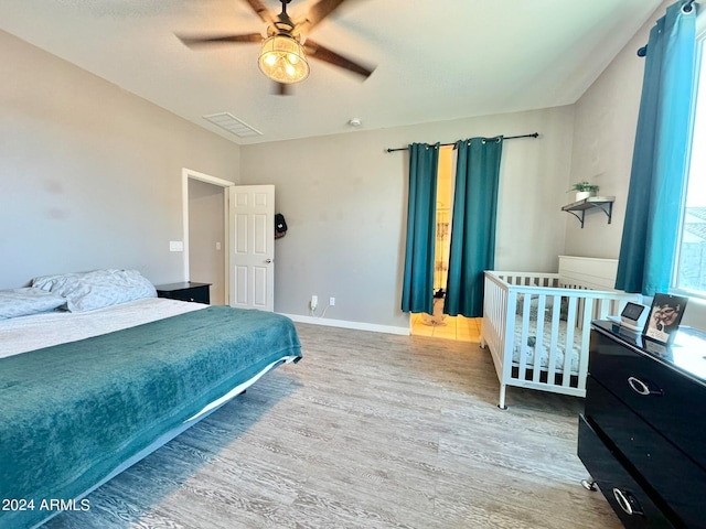 bedroom with ceiling fan and wood-type flooring