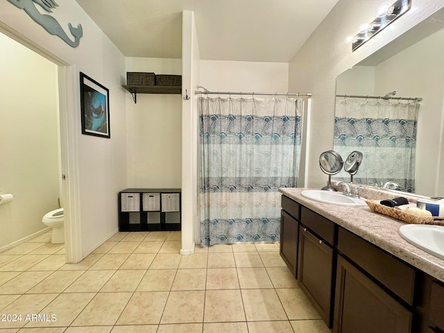 bathroom featuring a shower with shower curtain, tile patterned floors, vanity, and toilet