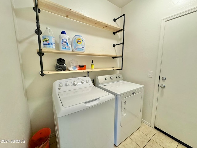 laundry area with light tile patterned floors and washer and dryer