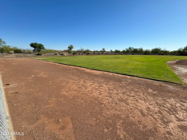 view of property's community featuring a rural view and a yard