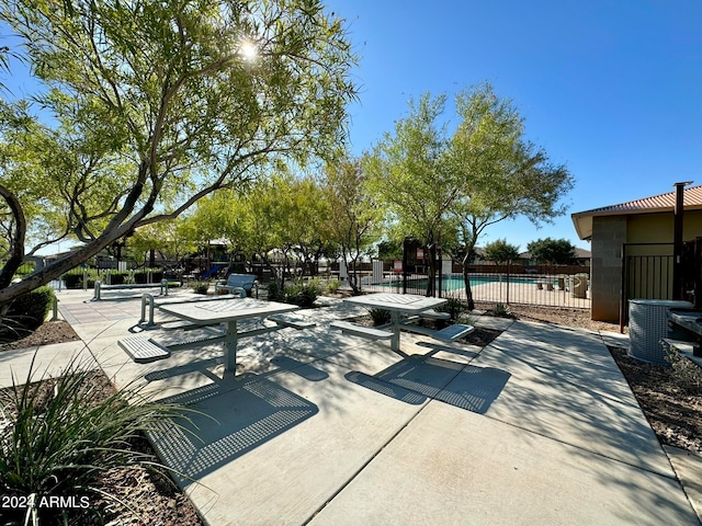 view of community featuring a pool and a patio area