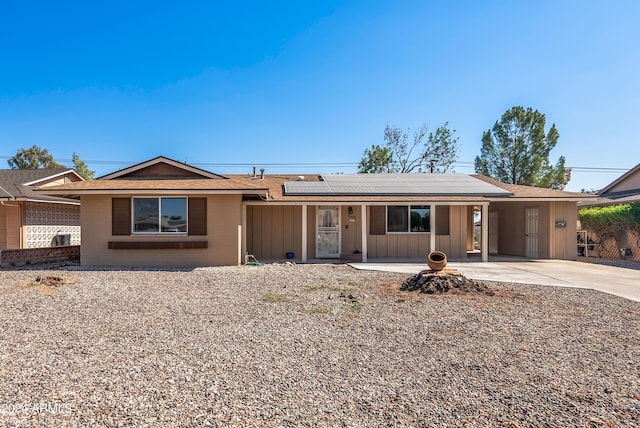 ranch-style home featuring solar panels