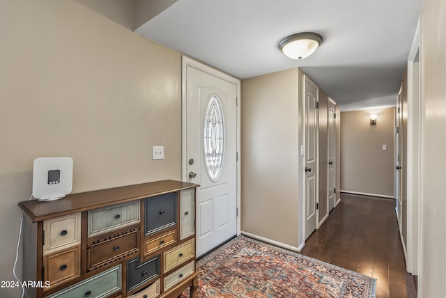 entryway with dark hardwood / wood-style flooring