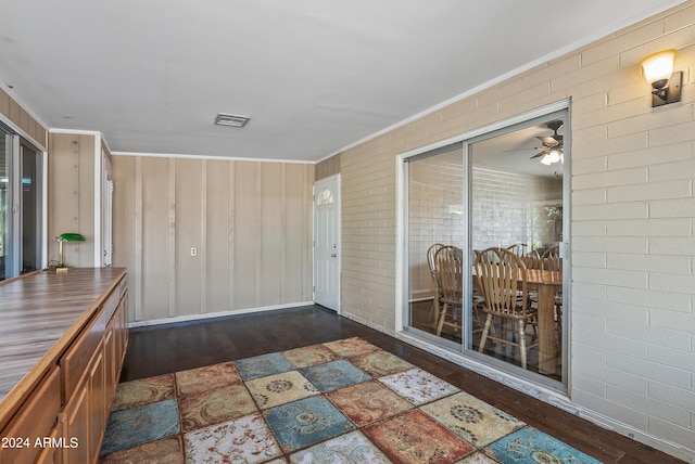 unfurnished sunroom featuring ceiling fan