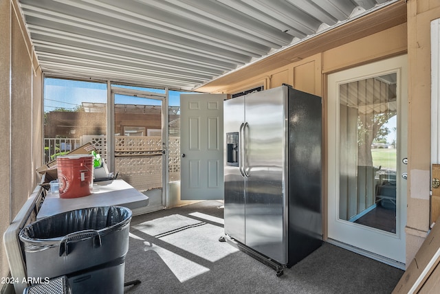 kitchen featuring carpet and stainless steel fridge