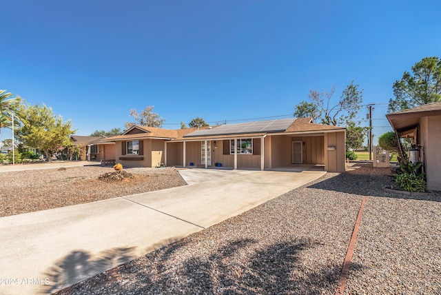 ranch-style home with solar panels