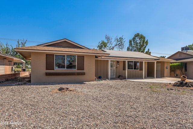 ranch-style home featuring a patio