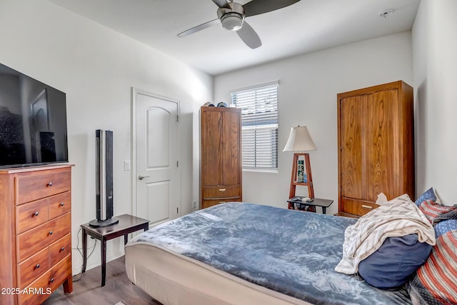 bedroom with light wood-type flooring and ceiling fan