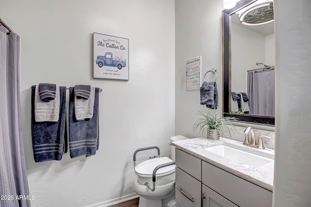 bathroom featuring vanity, curtained shower, and toilet