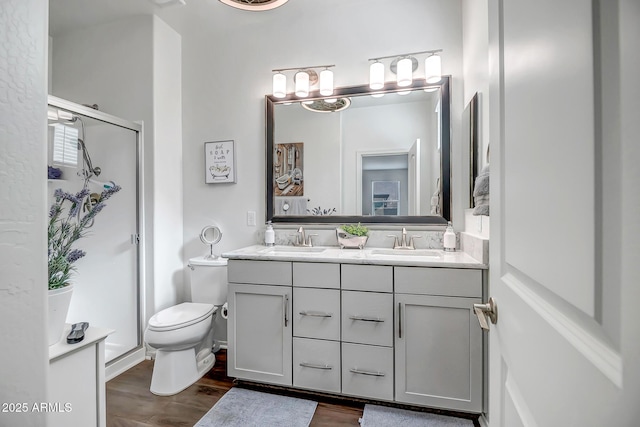 bathroom with vanity, hardwood / wood-style flooring, toilet, and walk in shower