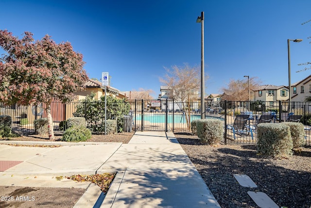 view of home's community featuring a swimming pool and a patio