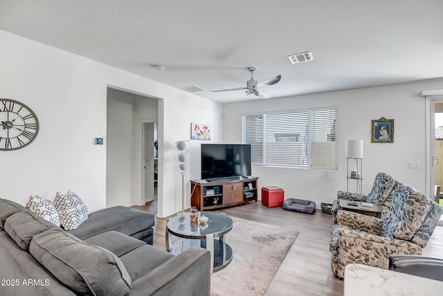 living room featuring ceiling fan and light hardwood / wood-style floors