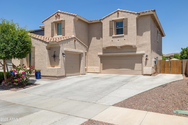 mediterranean / spanish house with stucco siding, an attached garage, a tile roof, and driveway
