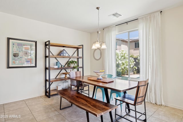 dining room featuring light tile patterned floors and baseboards
